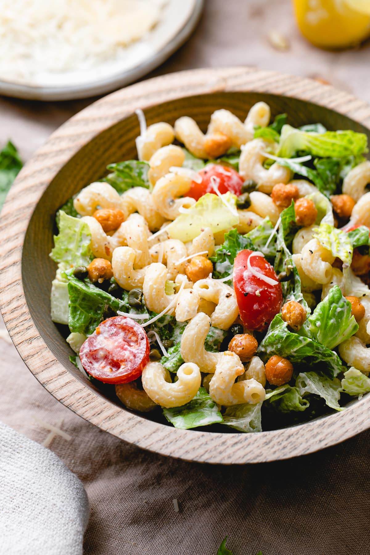 side angle view of caesar pasta salad in a bowl.