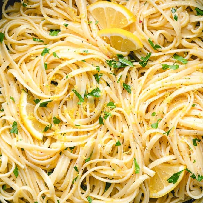 top down view of simple lemon pasta in a pot with items surrounding.