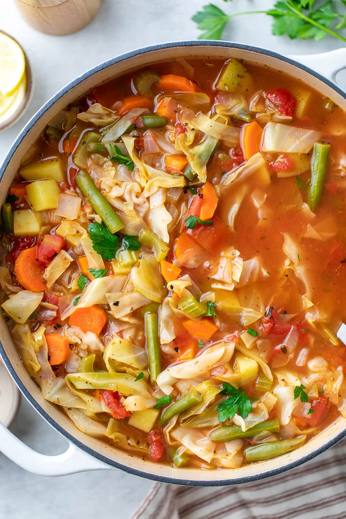 top down view of vegetable cabbage soup in a pot.