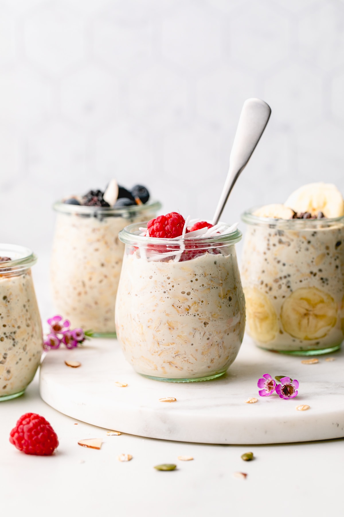 head on view of a group of mason jars with overnight oats with toppings.