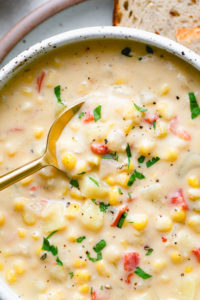 top down view of vegan corn chowder with spoon.