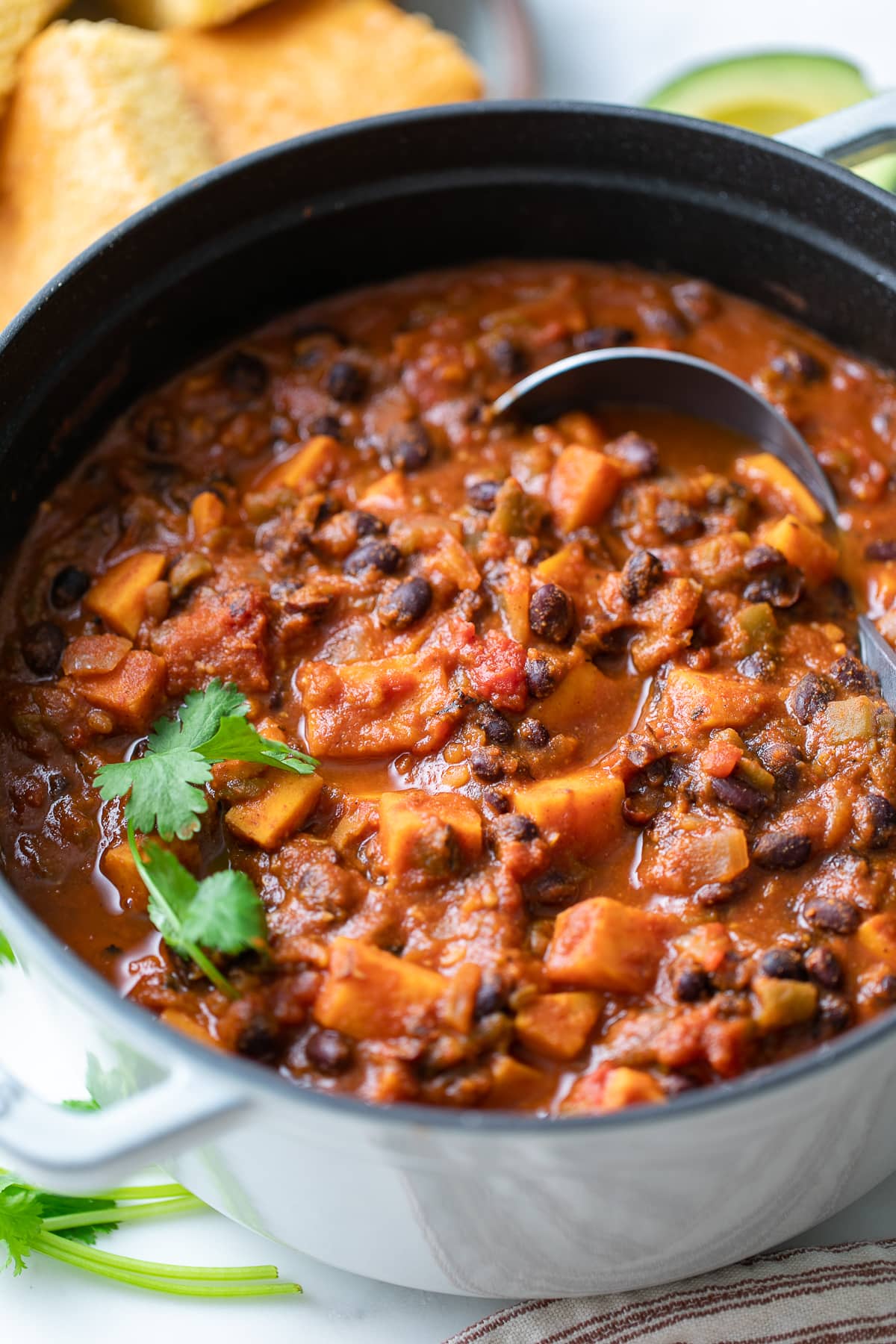 side angle view of freshly made pot of vegan sweet potato black bean chili.