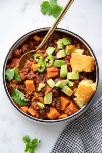 top down view of plated sweet potato black bean chili with toppings.