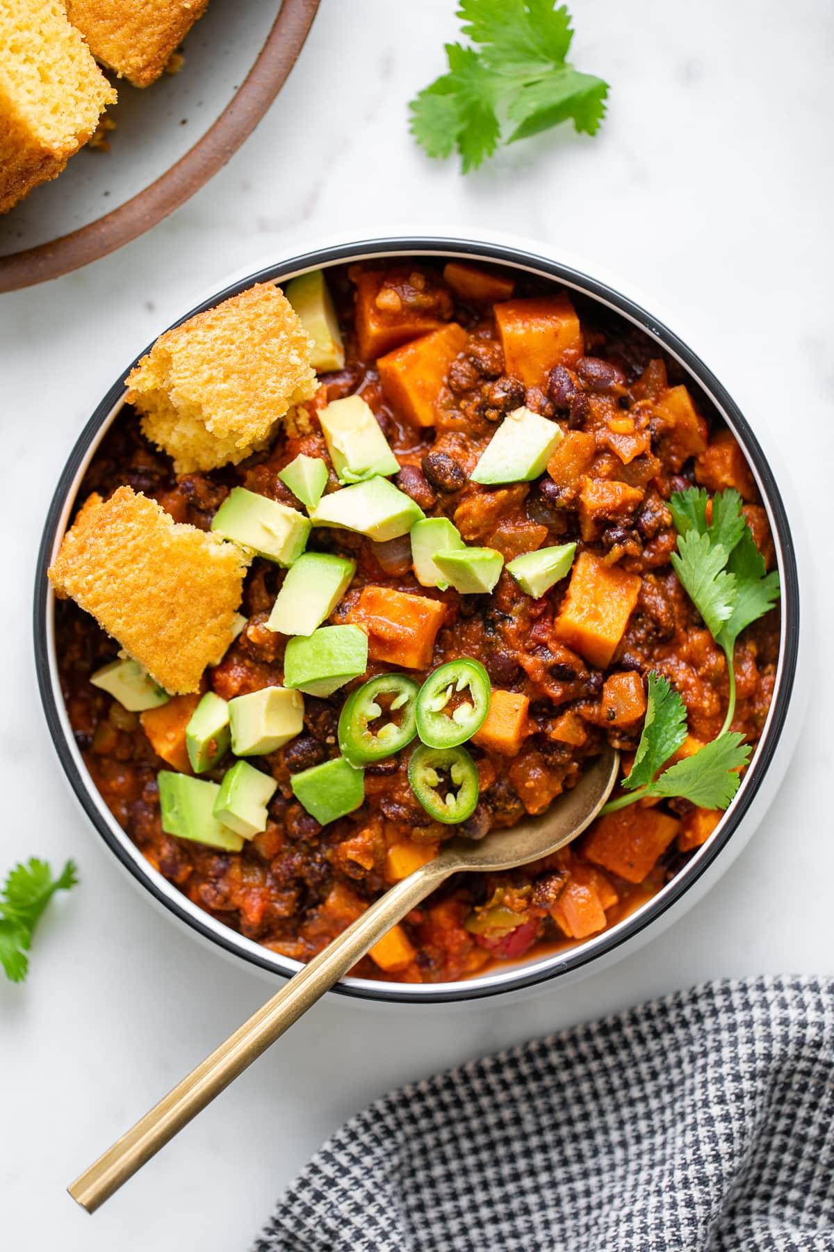 top down view of plated sweet potato black bean chili with toppings.