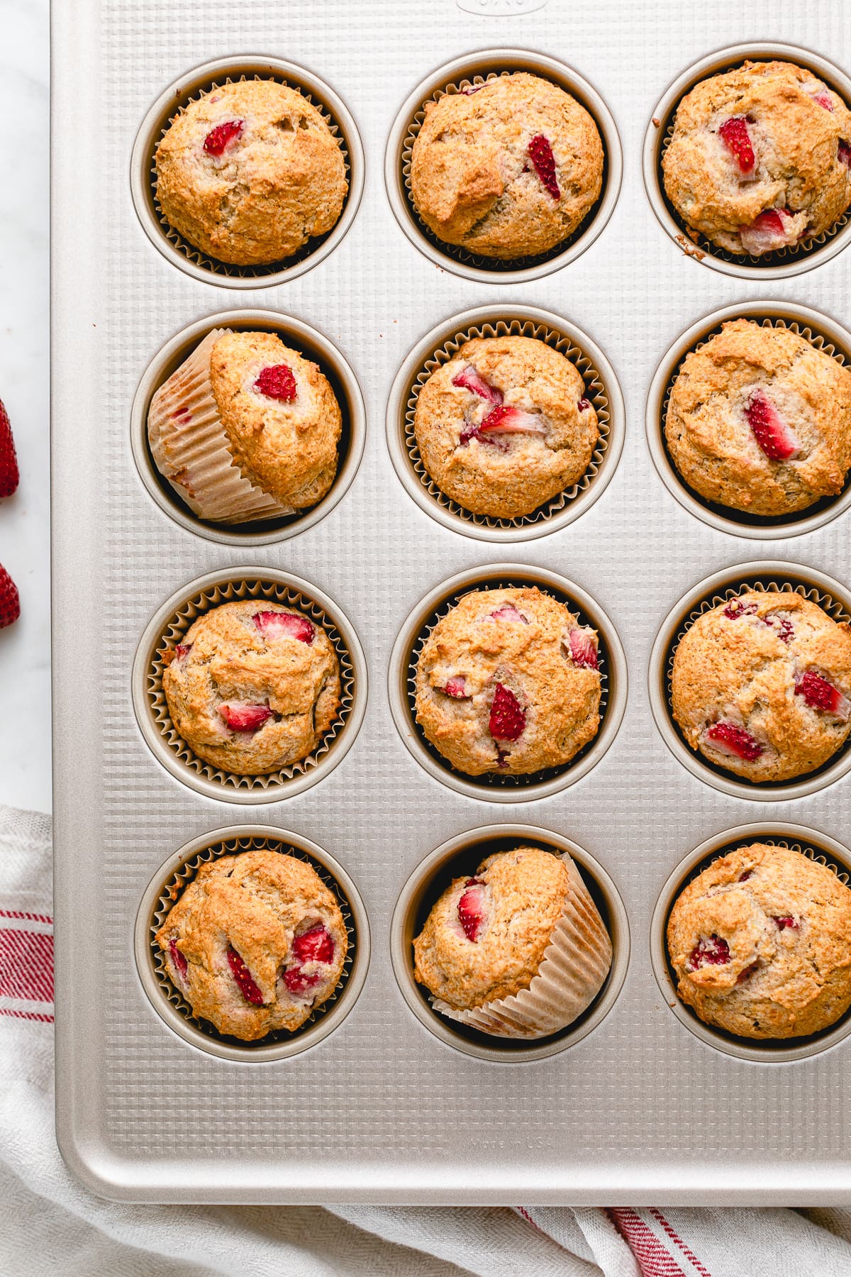top down view of freshly baked strawberry banana muffins in muffin tin.
