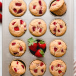 top down view of freshly baked vegan strawberry muffins in muffin tin.