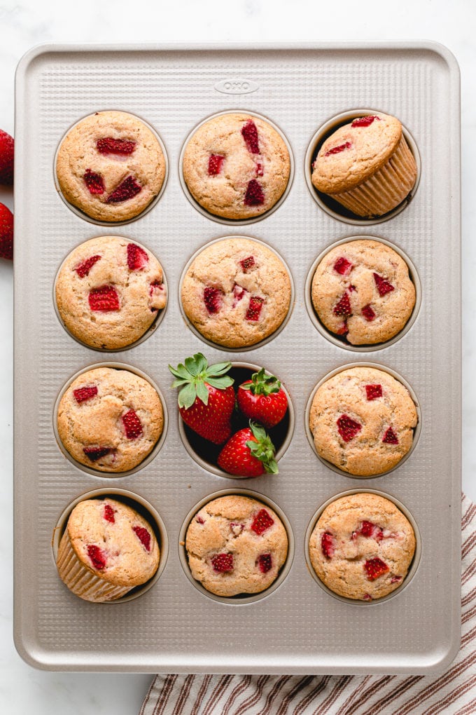 top down view of freshly baked vegan strawberry muffins in muffin tin.