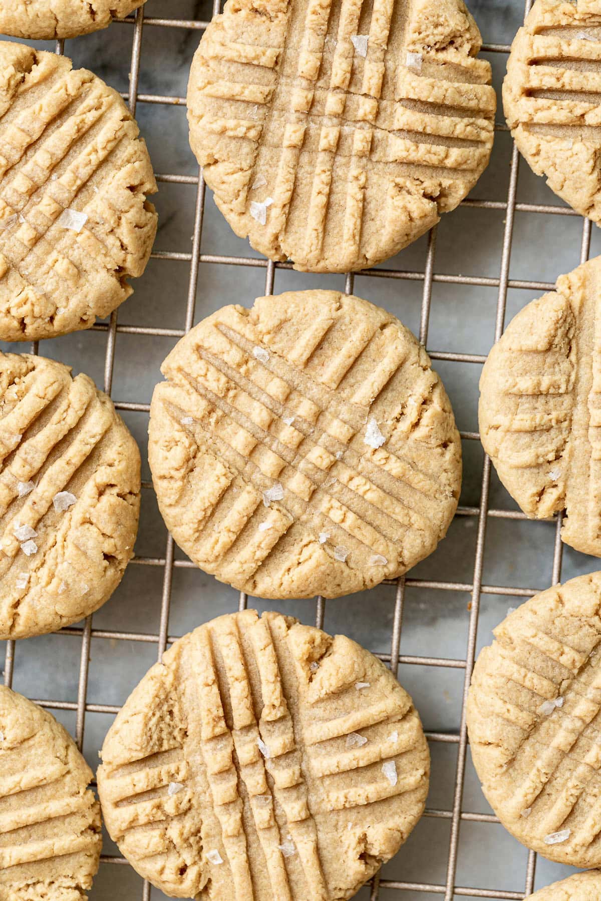 top down view of 3-ingredient almond flour peanut butter cookies on a wire rack.