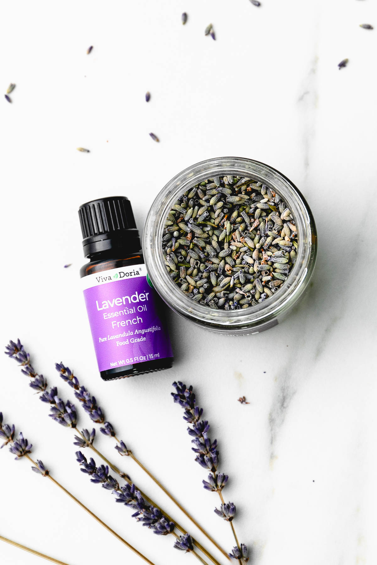 top down view of lavender essential oil and flower buds.