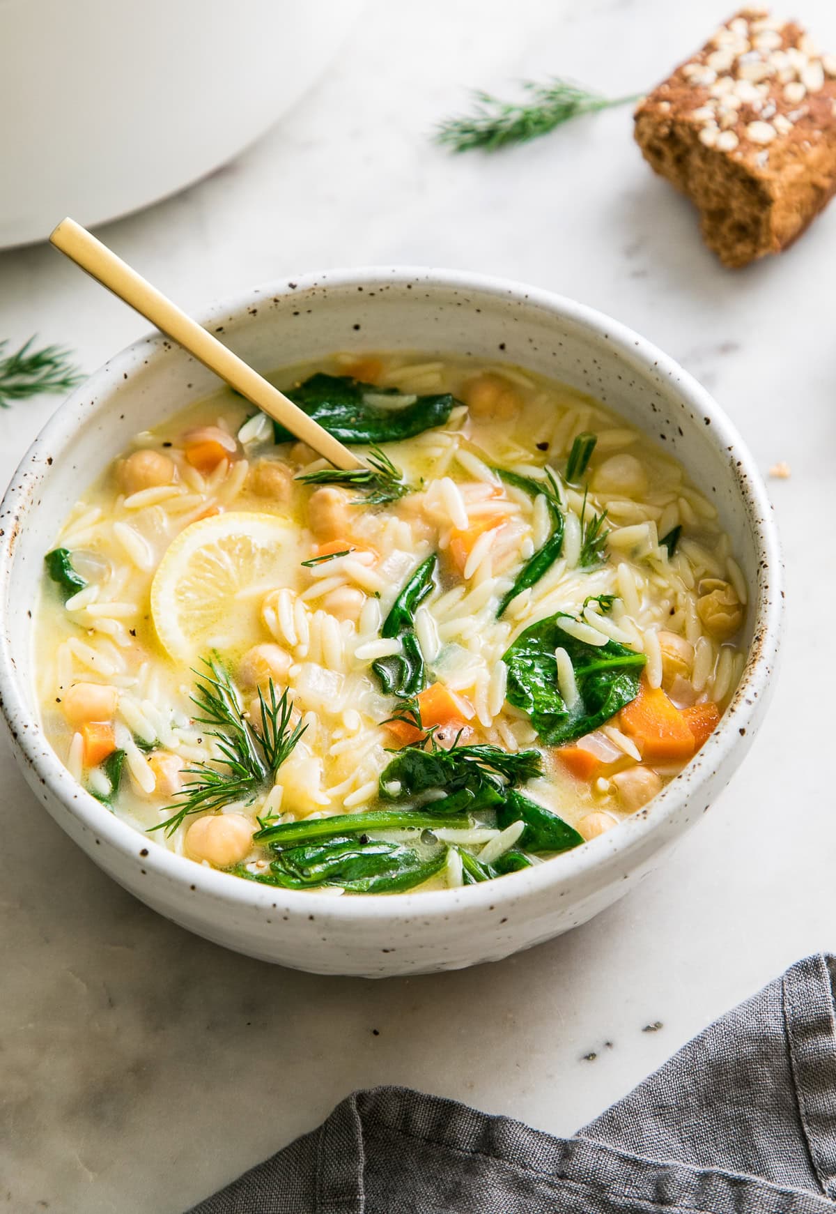 vegan creamy lemon chickpea orzo soup in a bowl.