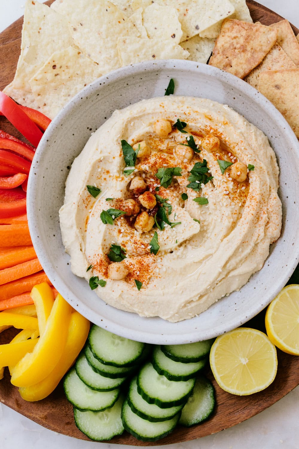 vegan appetizer platter with hummus, veggies, and chips.