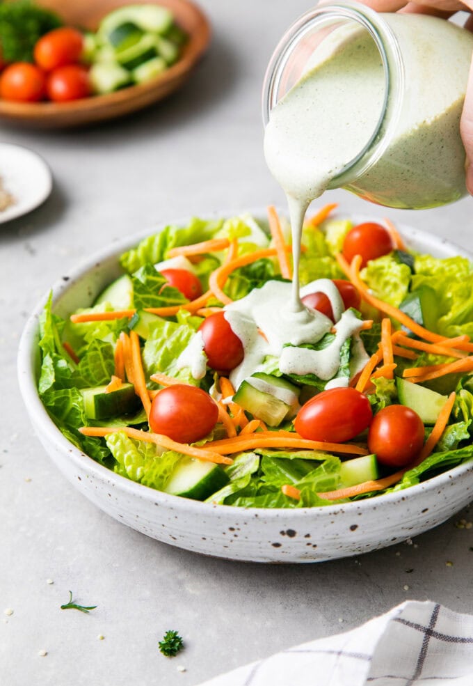 vegan hemp ranch dressing drizzled over fresh salad greens.