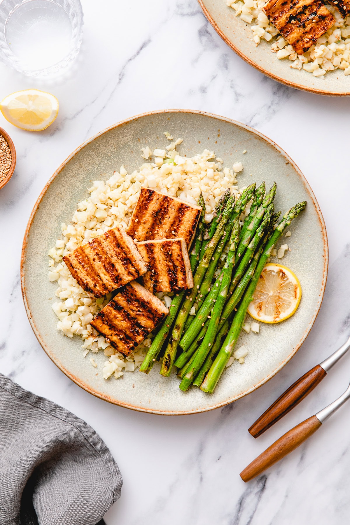 healthy vegan grain-free bowl with cauliflower rice, roasted veggies, and tofu.