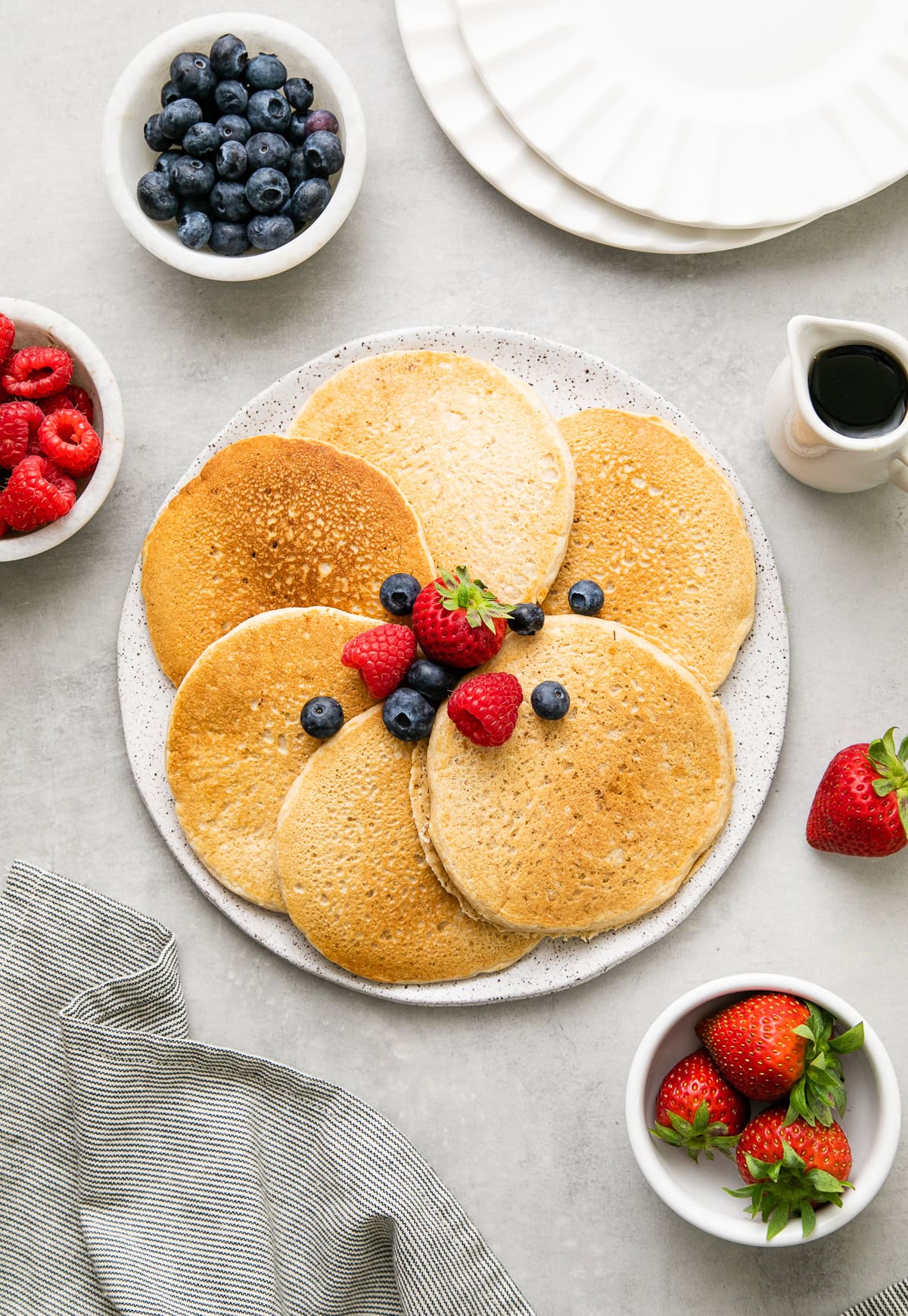 kid-friendly vegan pancakes with berries and maple syrup.