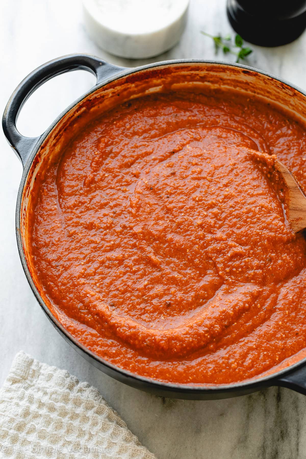 Vegan tomato sauce in a black skillet, ready to serve with pasta or dishes.