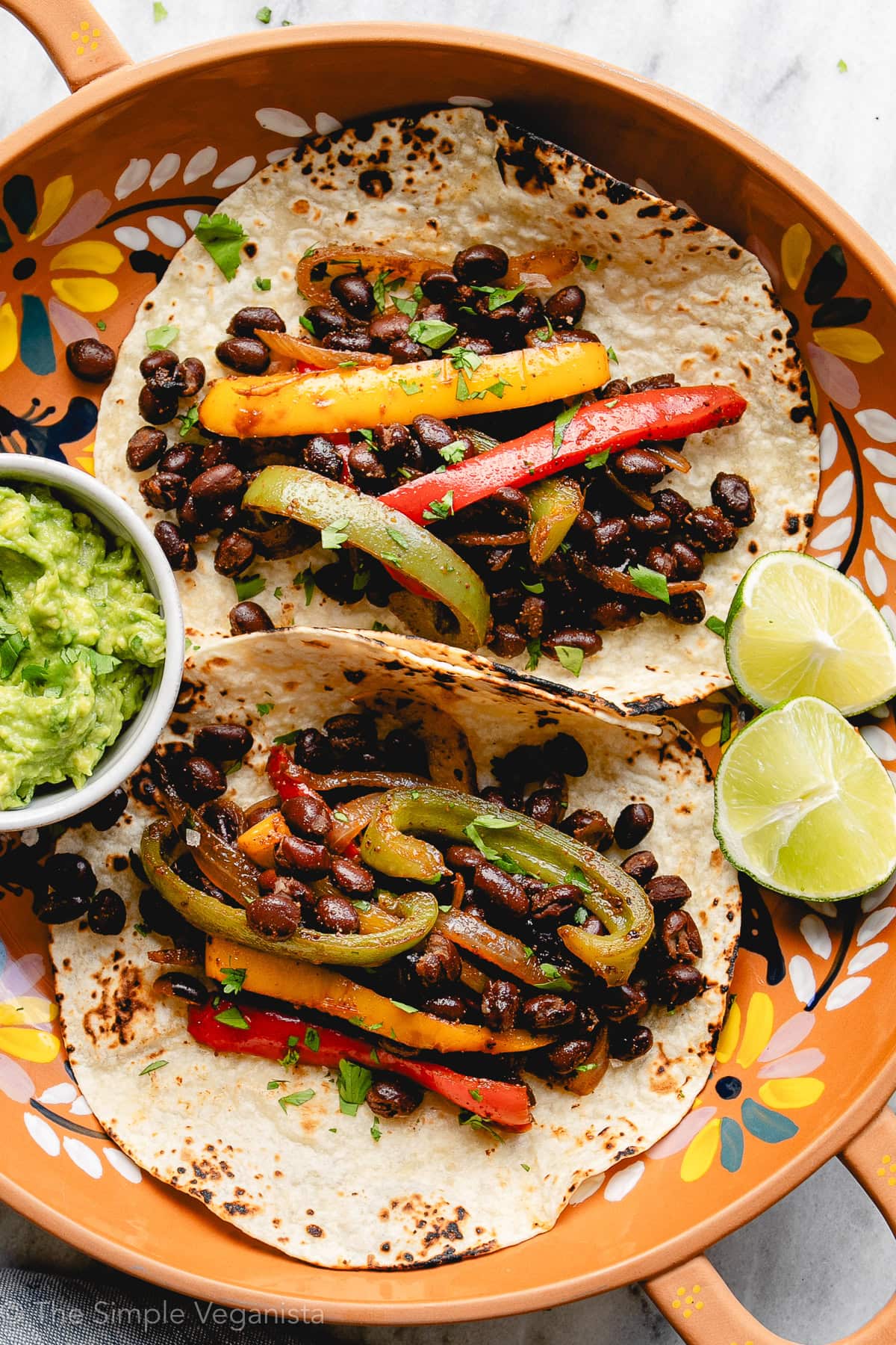 Vegan black bean fajitas with sautéed peppers, onions, and warm tortillas.